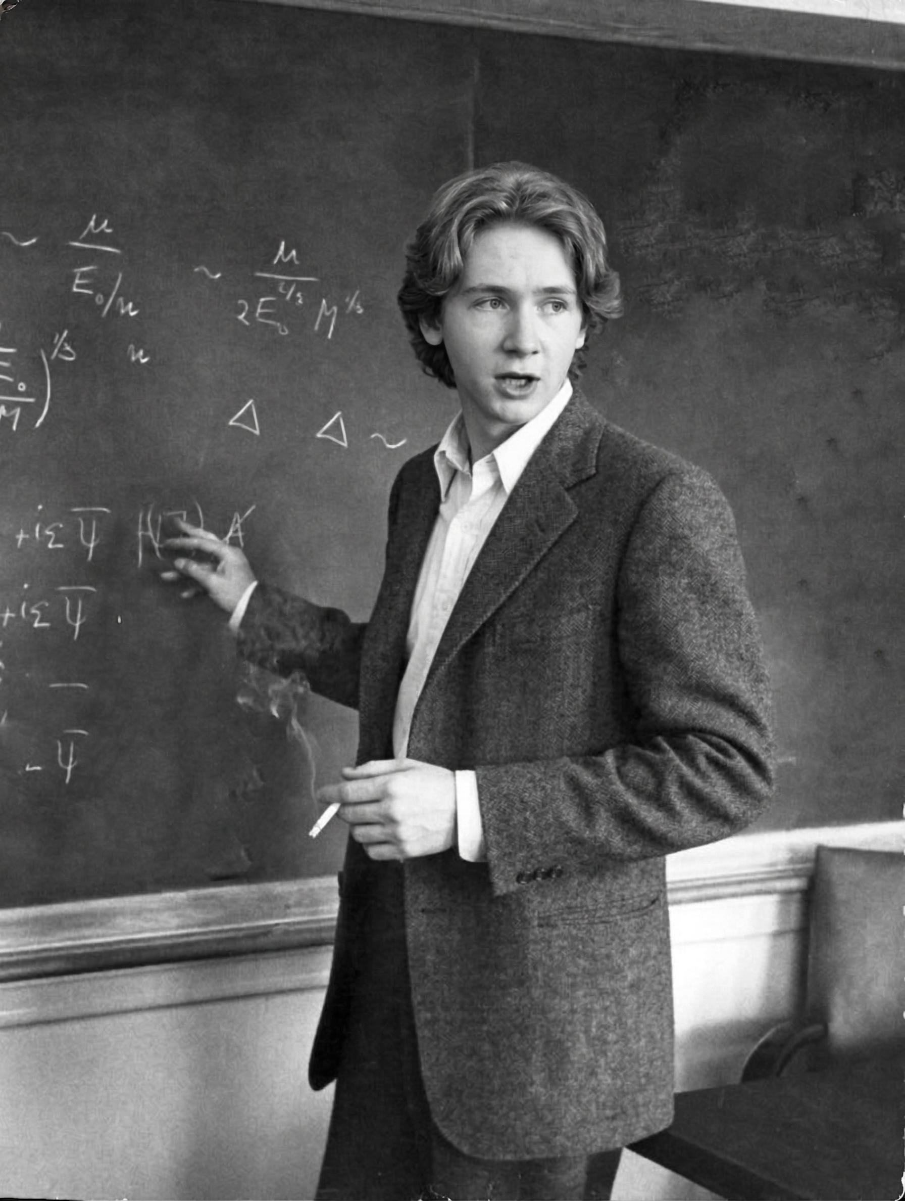 Black-and-white photograph of a lecturer at a chalkboard